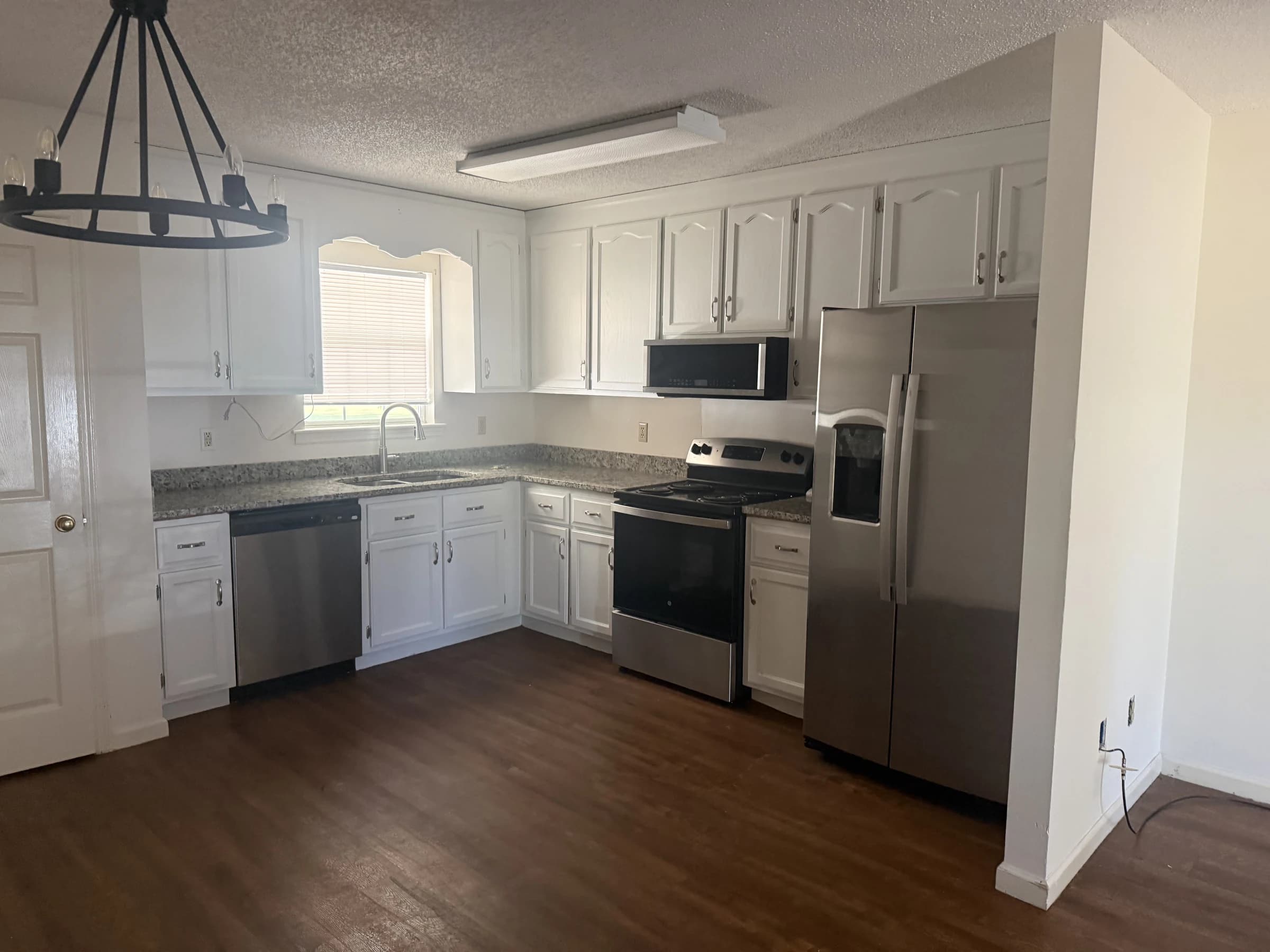 Renovated New Horizon kitchen with white cabinetry and stainless appliances